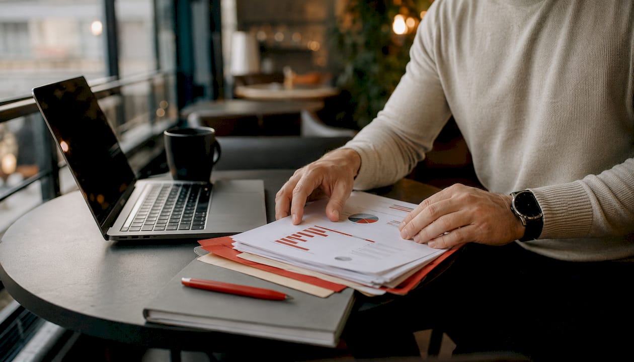 Hands organizing marketing data printouts
