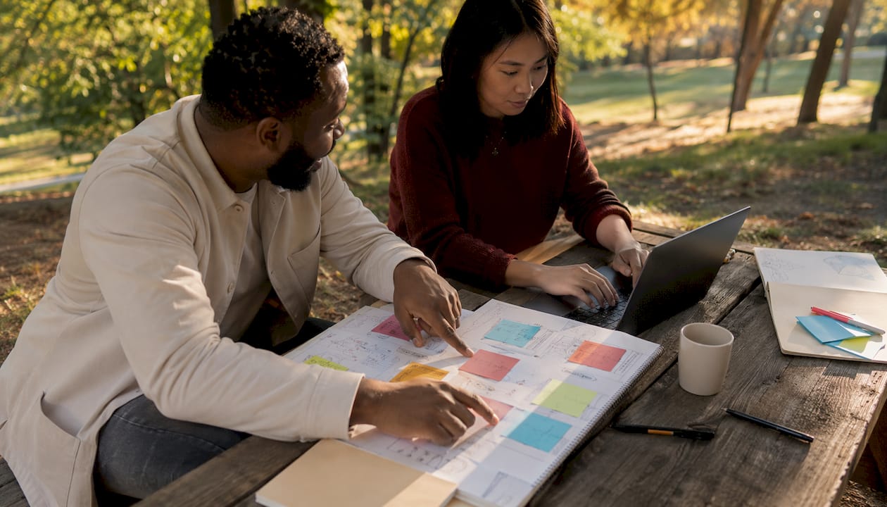Two professionals collaborating on marketing audit action plan