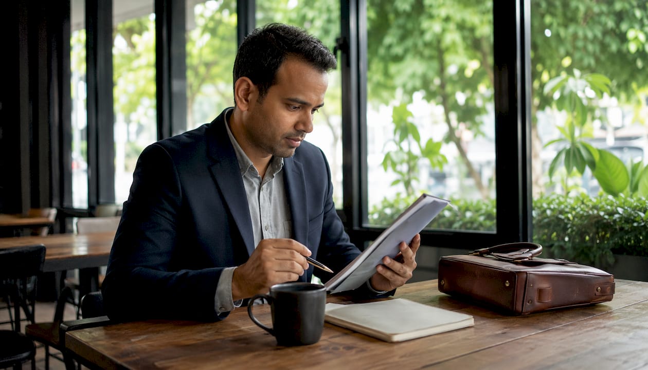 Man annotating insurance policy documents