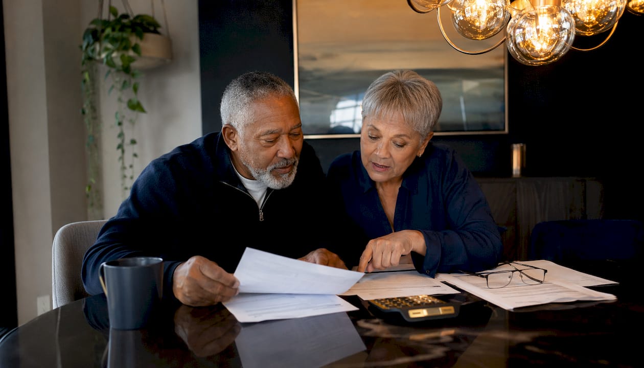 Senior couple reviewing Social Security benefits at home