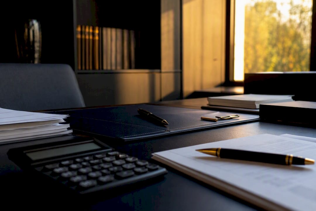 Dark navy desk with financial tools and gold accents