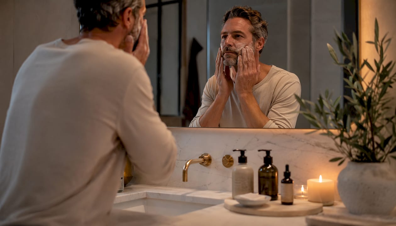Man applying water-based cleanser at night