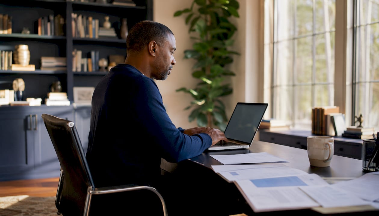 Hands using laptop for UiPath Orchestrator management