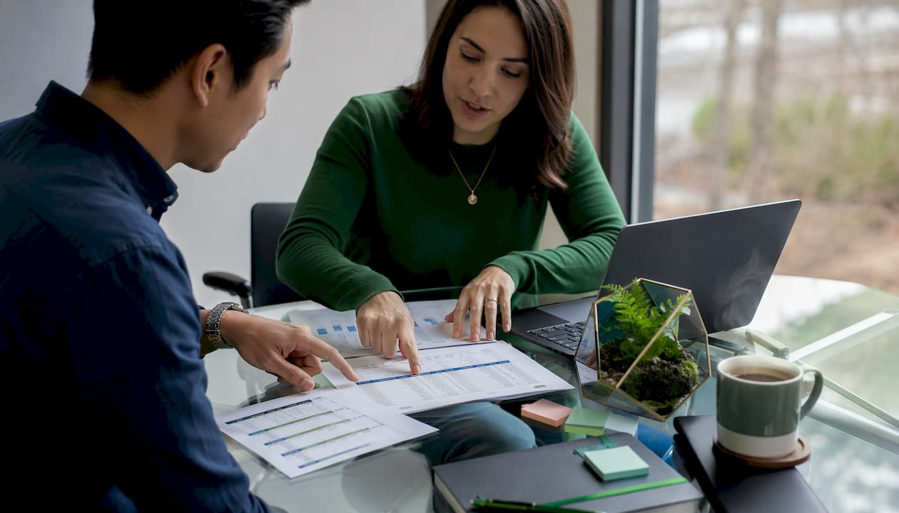 Two people discussing software comparison