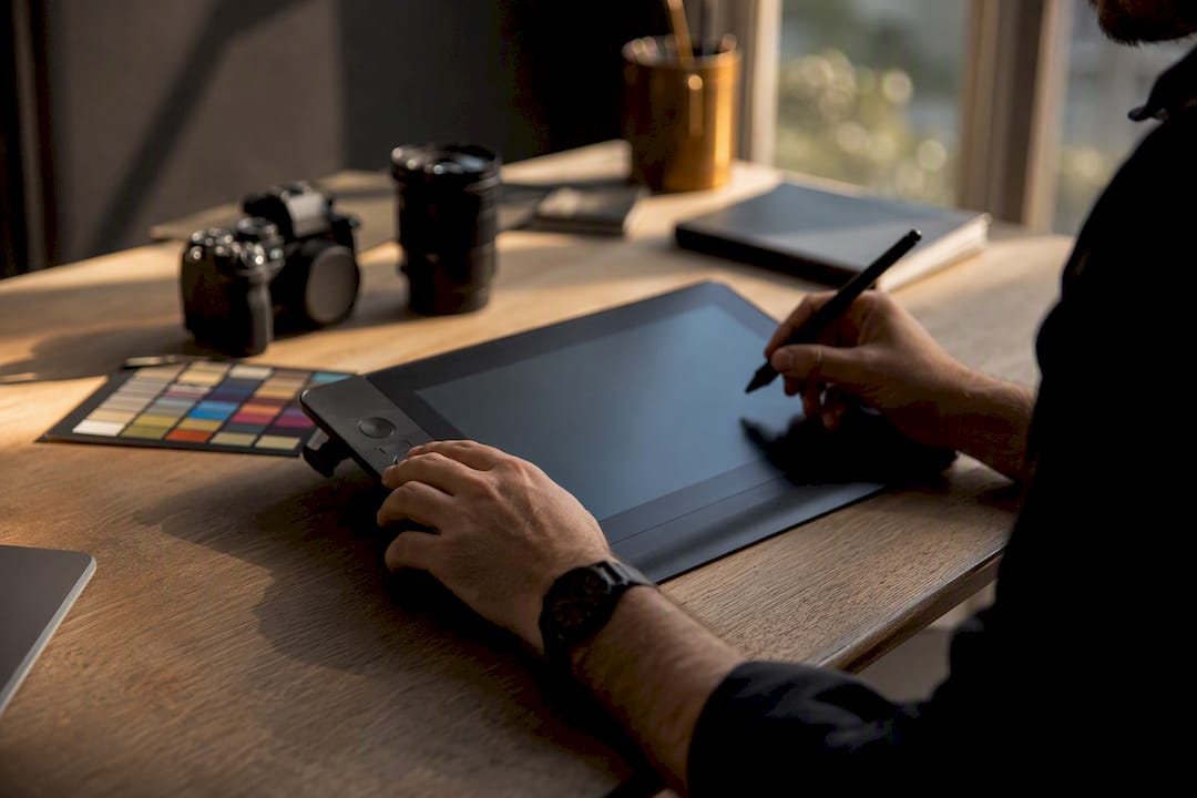 Hands compressing and resizing images on tablet
