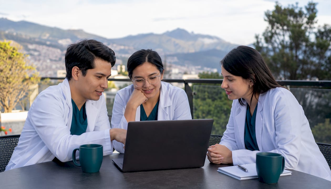 Persona trabajando en un portátil dentro de una clínica privada moderna