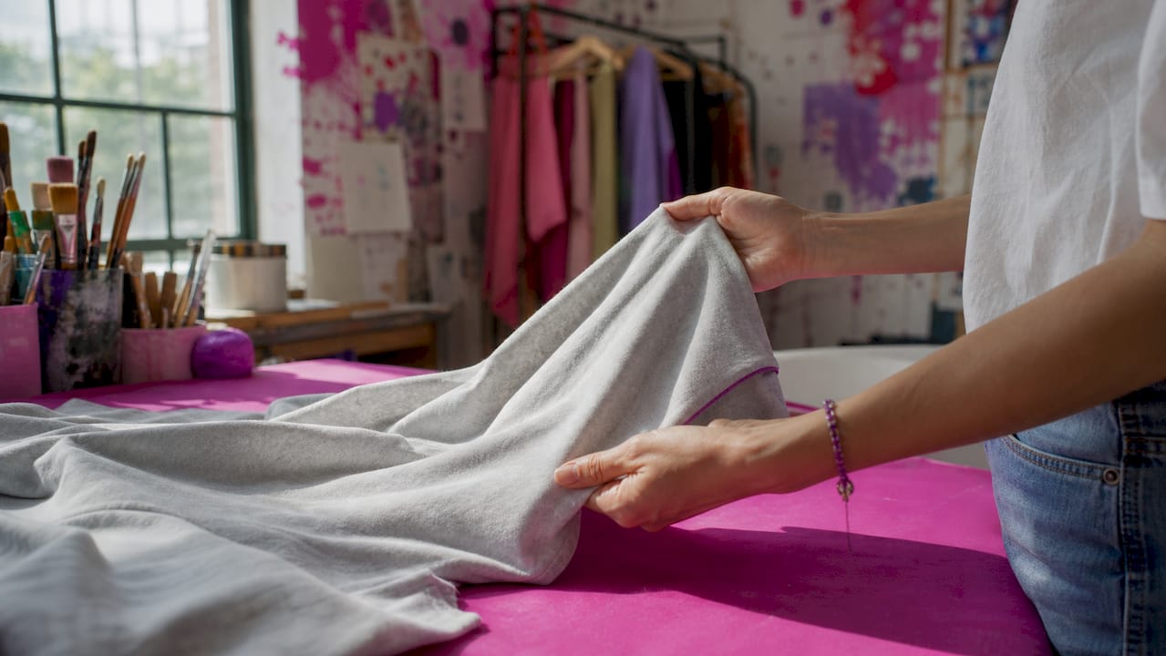 Close-up of hands touching cotton fabric