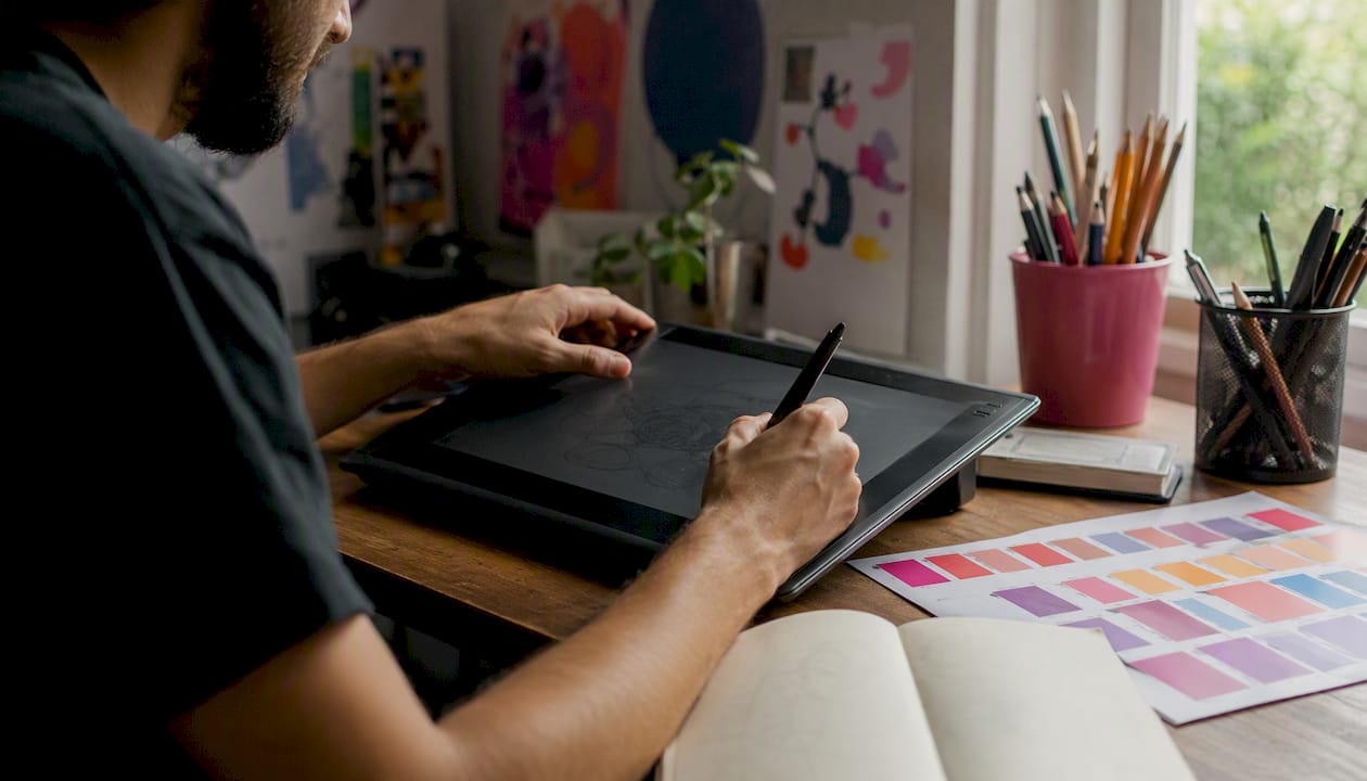Hands drawing vector paths on graphics tablet