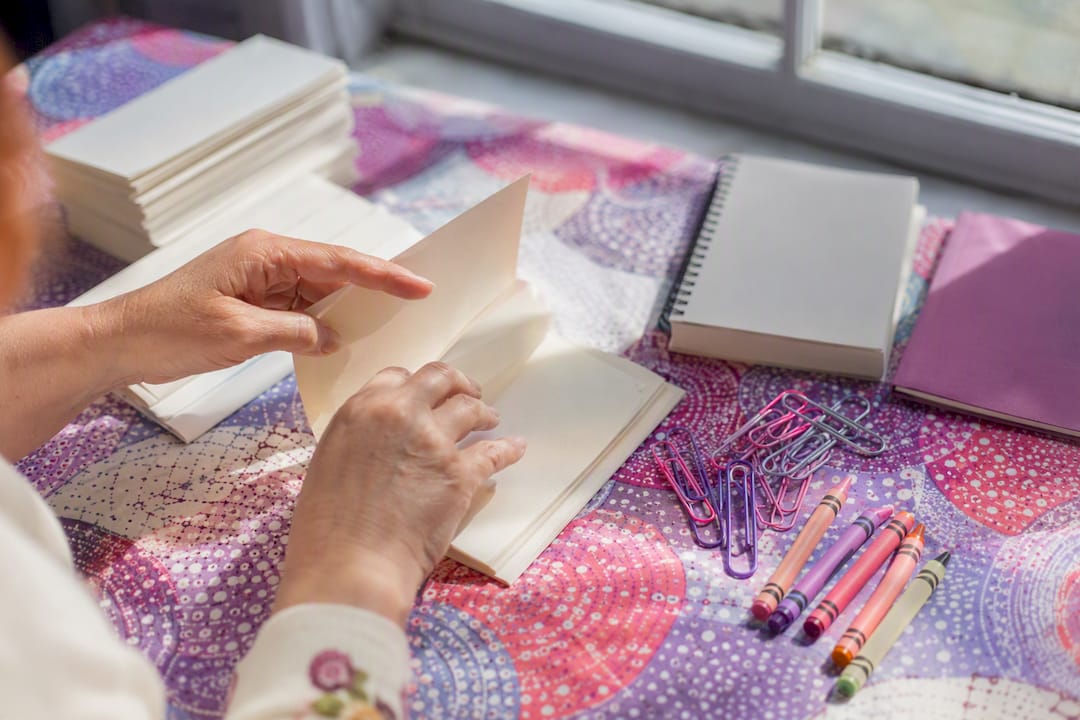 Hands preparing teacher thank you cards