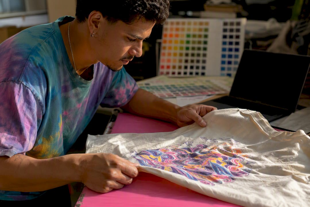 Technician inspecting cotton t-shirt print quality