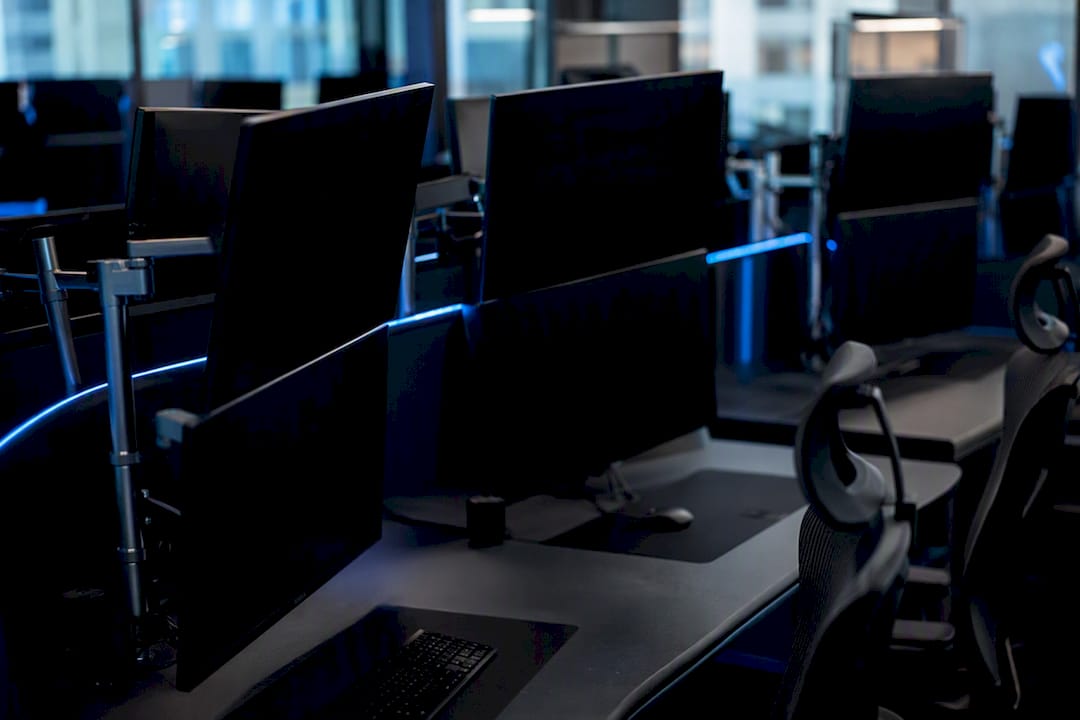 Dark brokerage terminals with blue ambient lighting