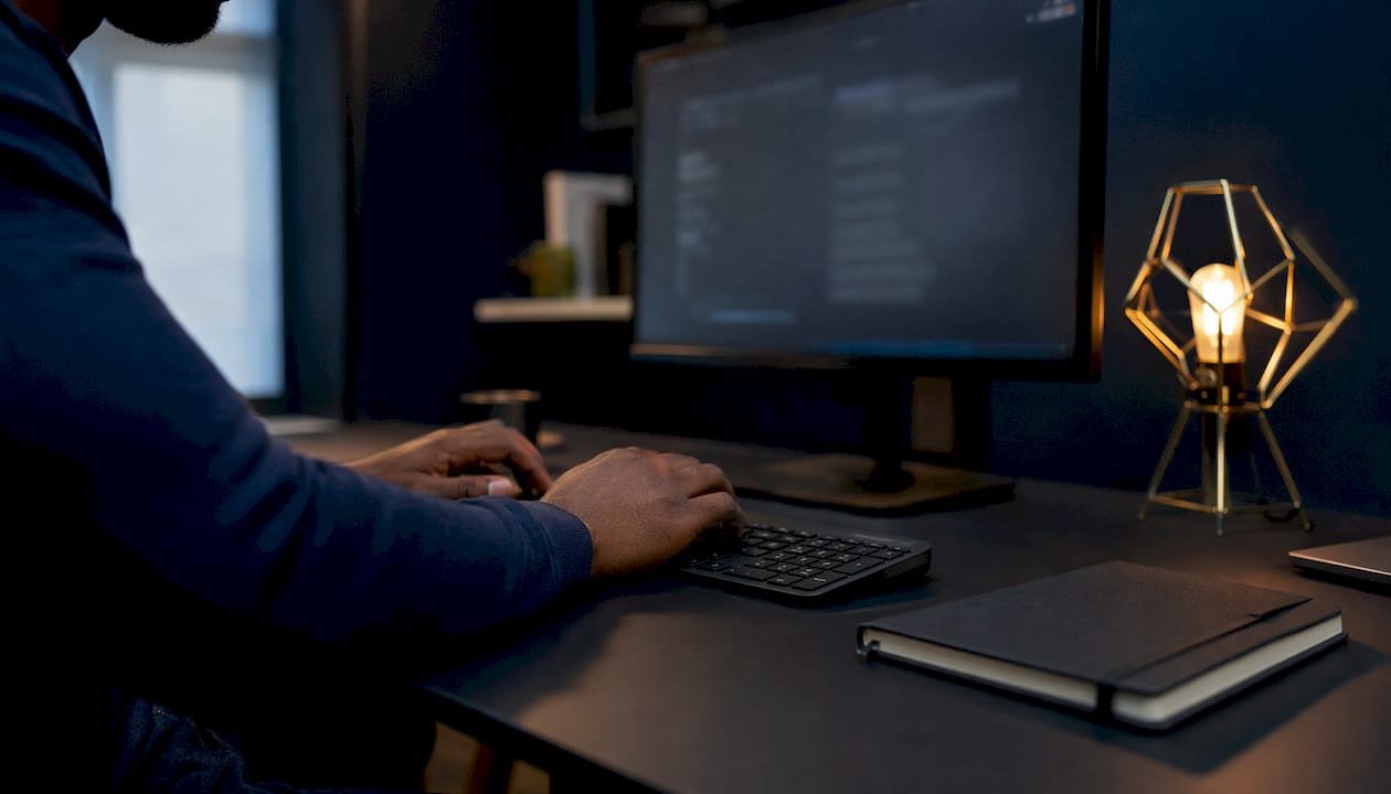 Hands typing subtitle translation notes and computer