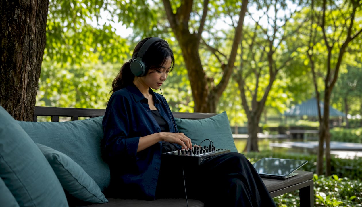 Woman adjusting audio mixer during AI dubbing session