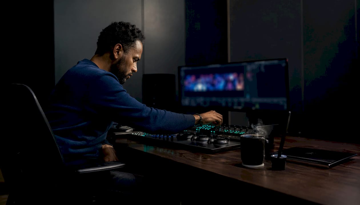 Hands operating video editing console
