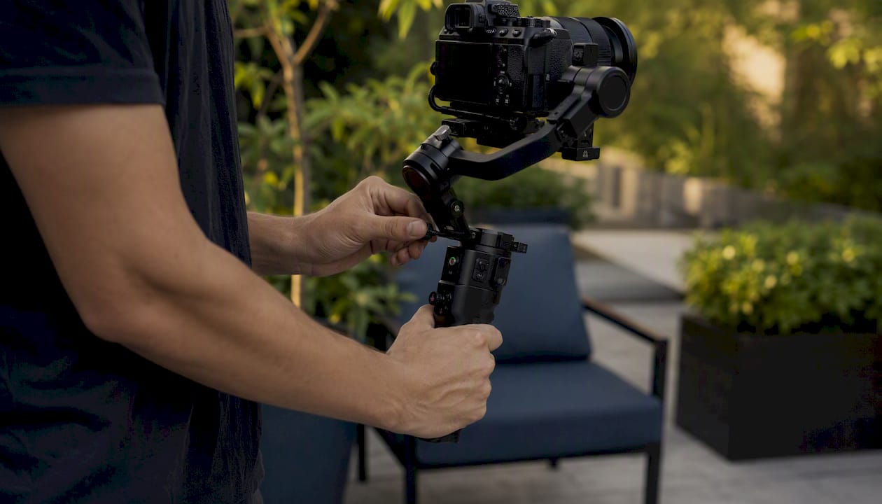 Hands adjusting camera gimbal stabilizer