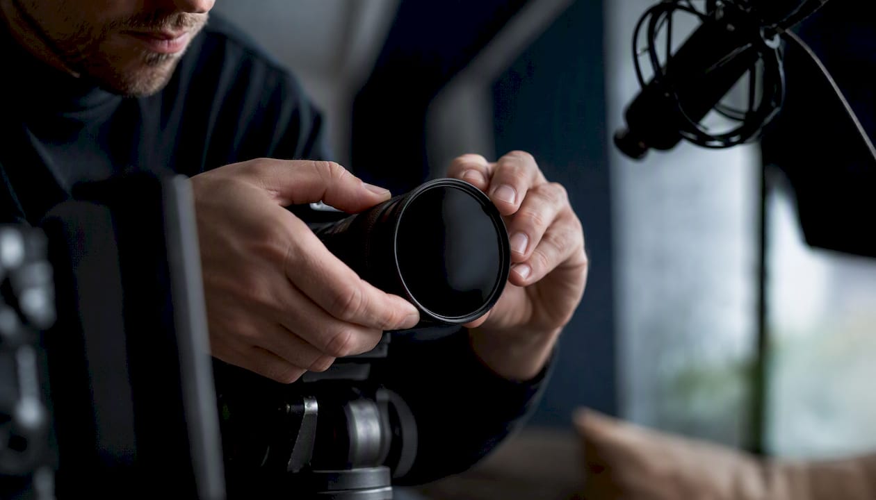 Hands fitting privacy filter on camera lens