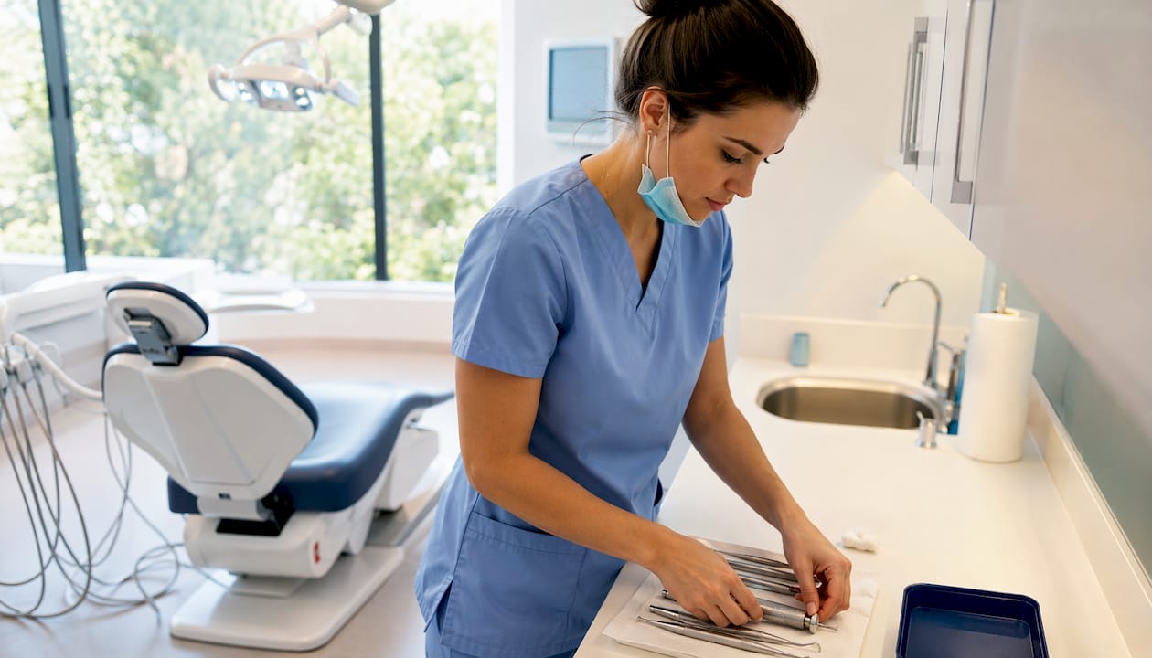 Dental hygienist preparing tools in clinic