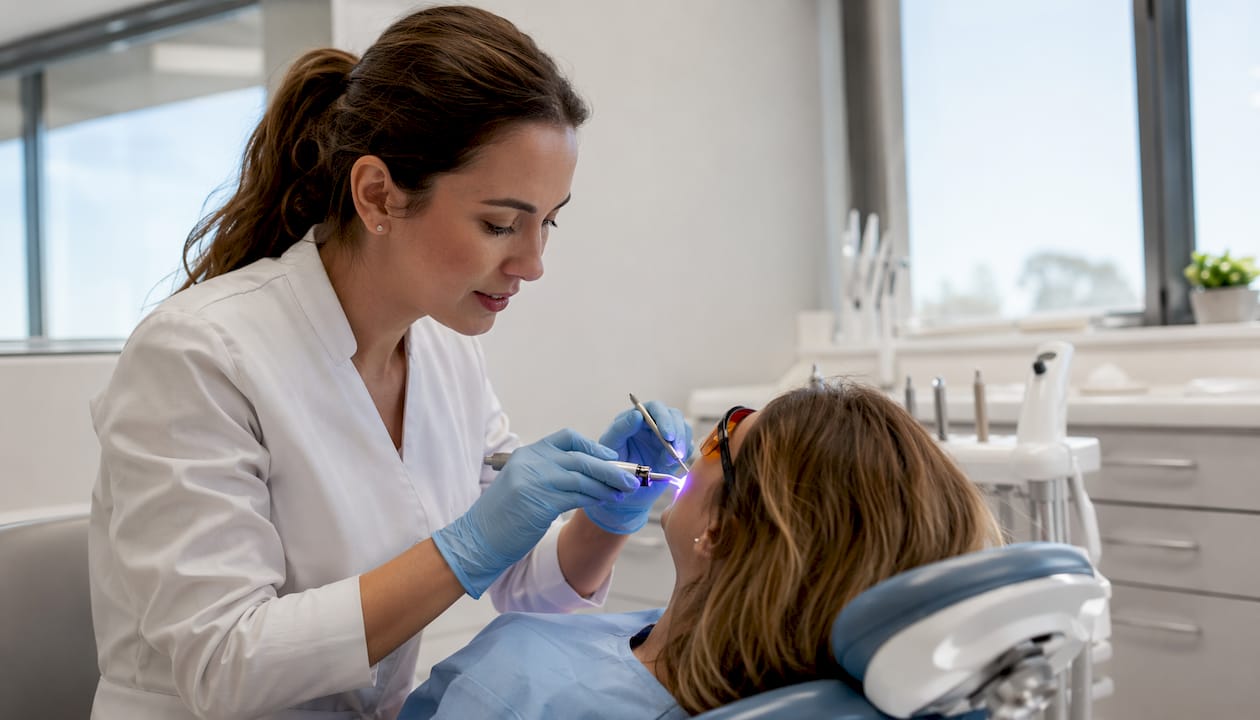 Dentist performing edge bonding in clinic