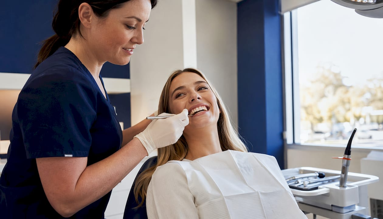 Dentist applying composite bonding to patient's teeth