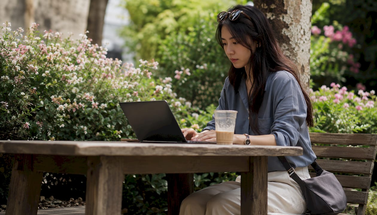Digital nomad using laptop at outdoor café