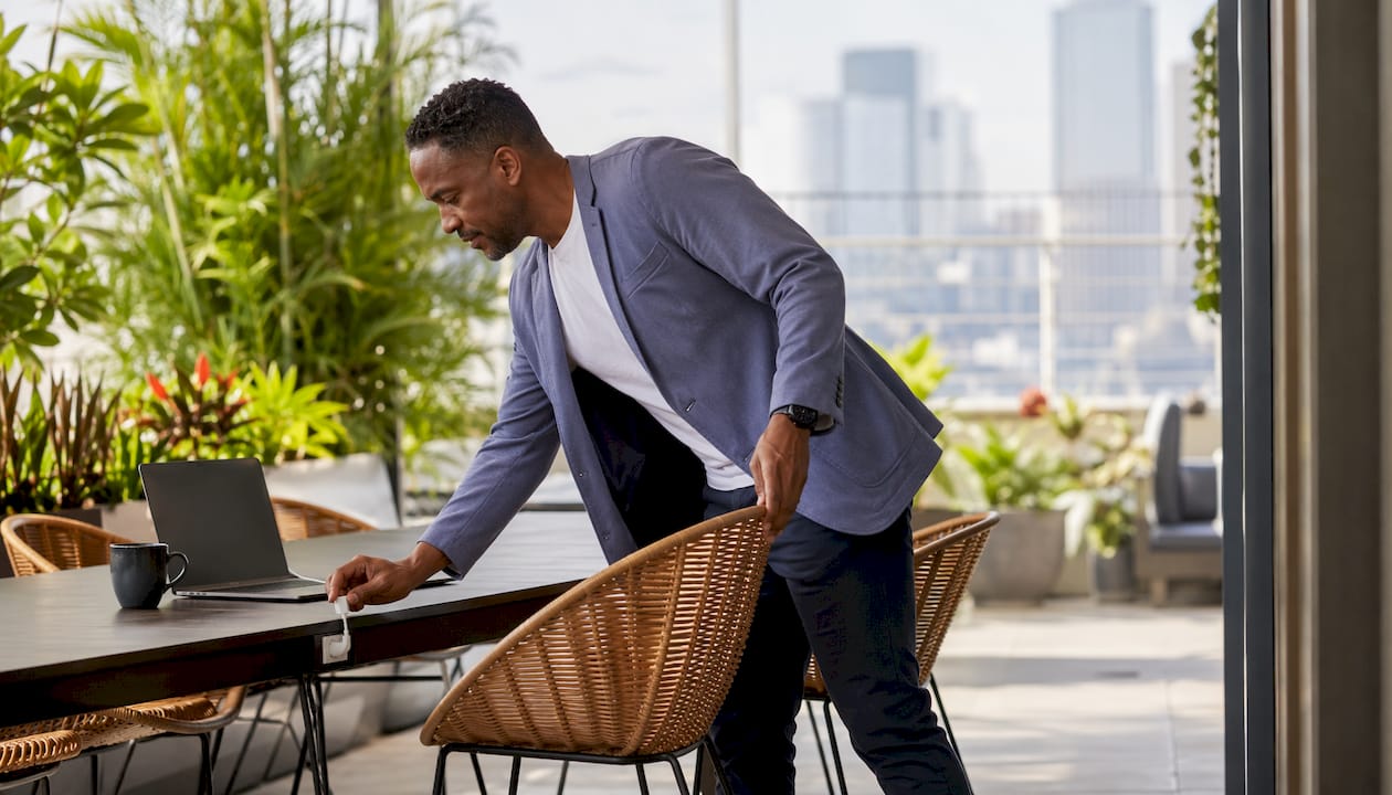 Man setting up at hot desk workspace
