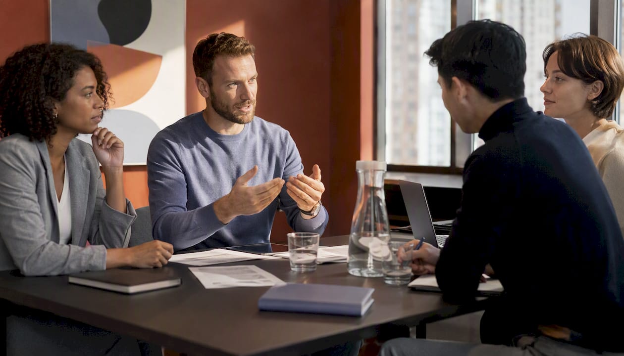 Small team meeting in private office from above