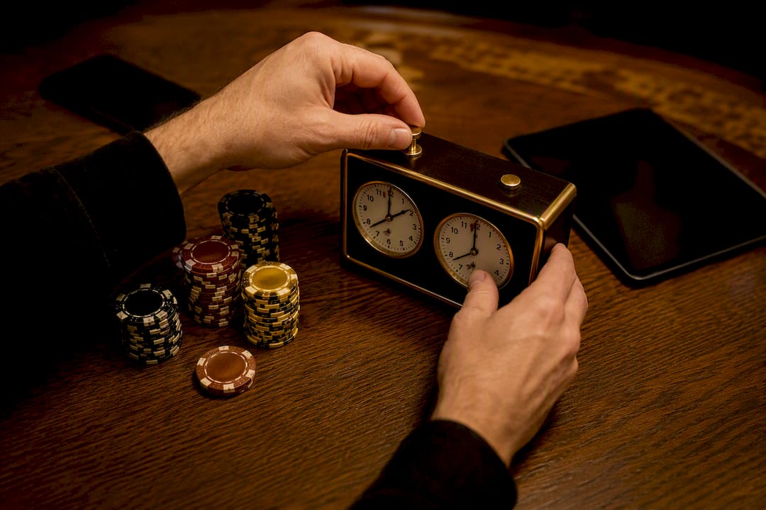 Hands adjusting tournament clock for live syncing