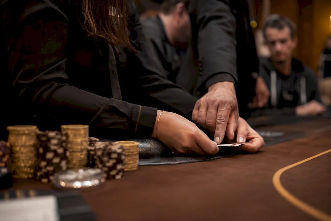 Dealer hands quietly correcting exposed card