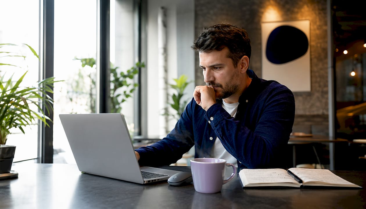 Person working on Shopify SEO technical setup at desk
