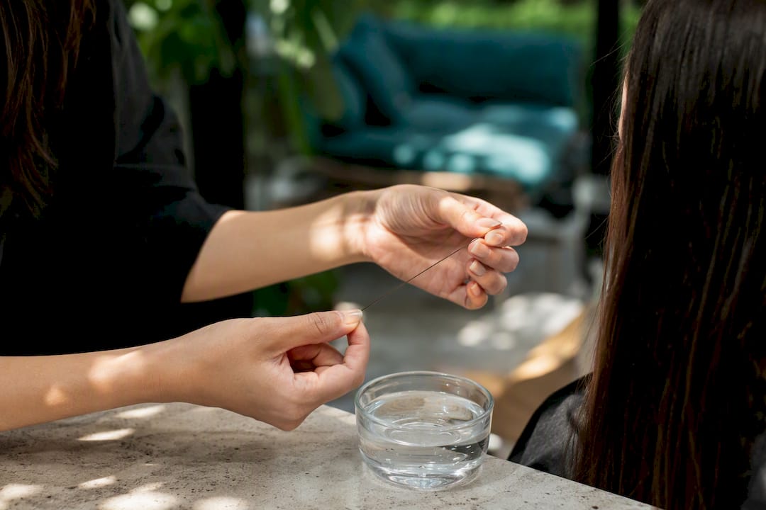 Stylist conducting hair strand diagnostic test