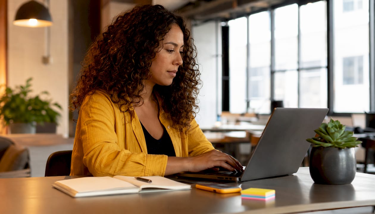 SEO specialist working on laptop in café