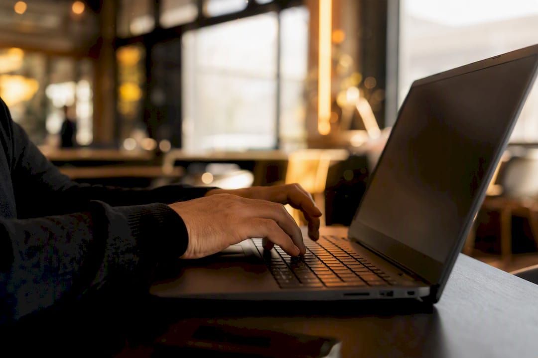 Hands typing schema markup code on keyboard