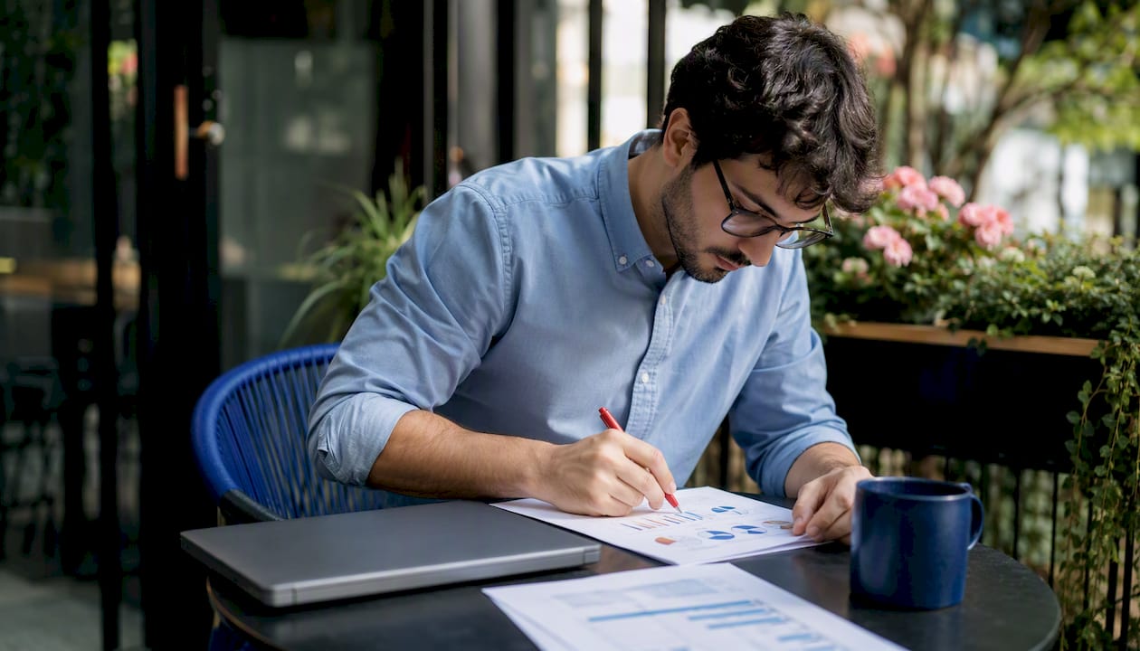 Sales Ops analyst reviewing reports at home office