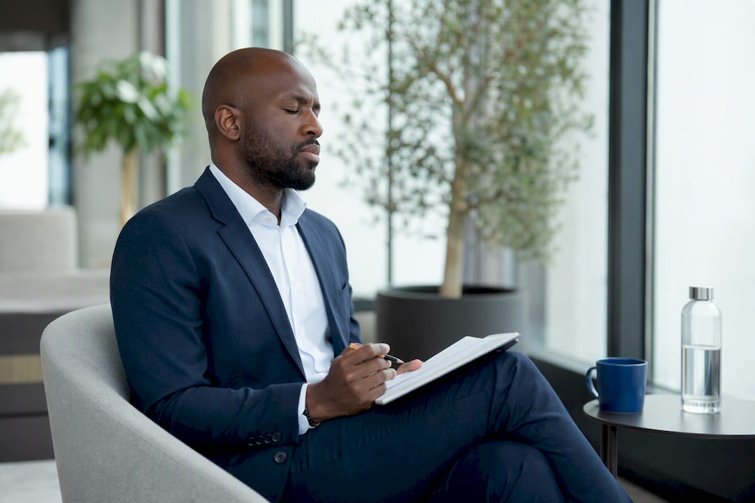 Sales leader praying thoughtfully in meeting room