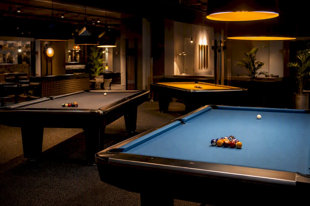 Four pool tables showing cloth and lighting differences