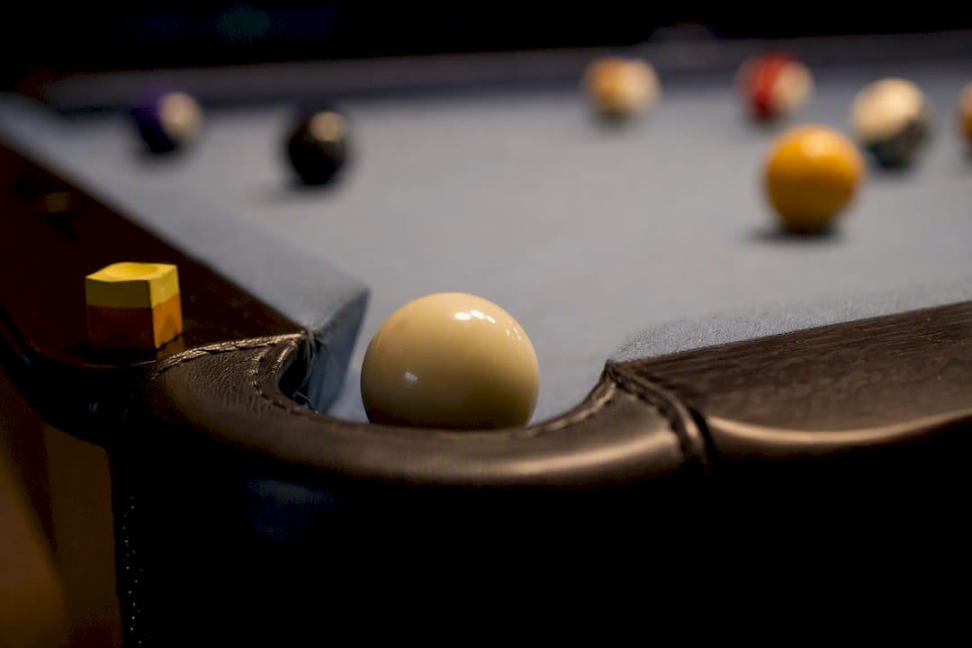 Cue ball dropping into a pool pocket