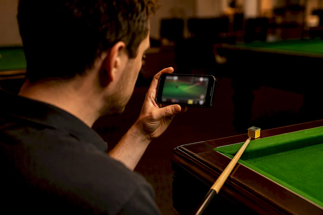 Player reviewing recorded snooker cue action