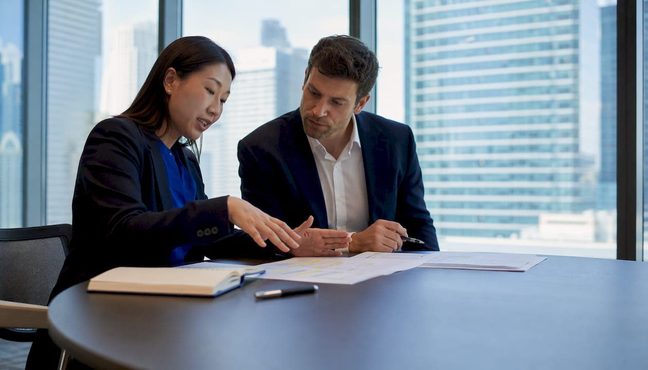 Financial officers reviewing regulatory drafts