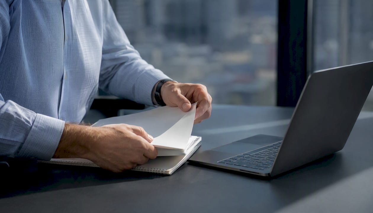 Hands calculating portfolio risk with calculator