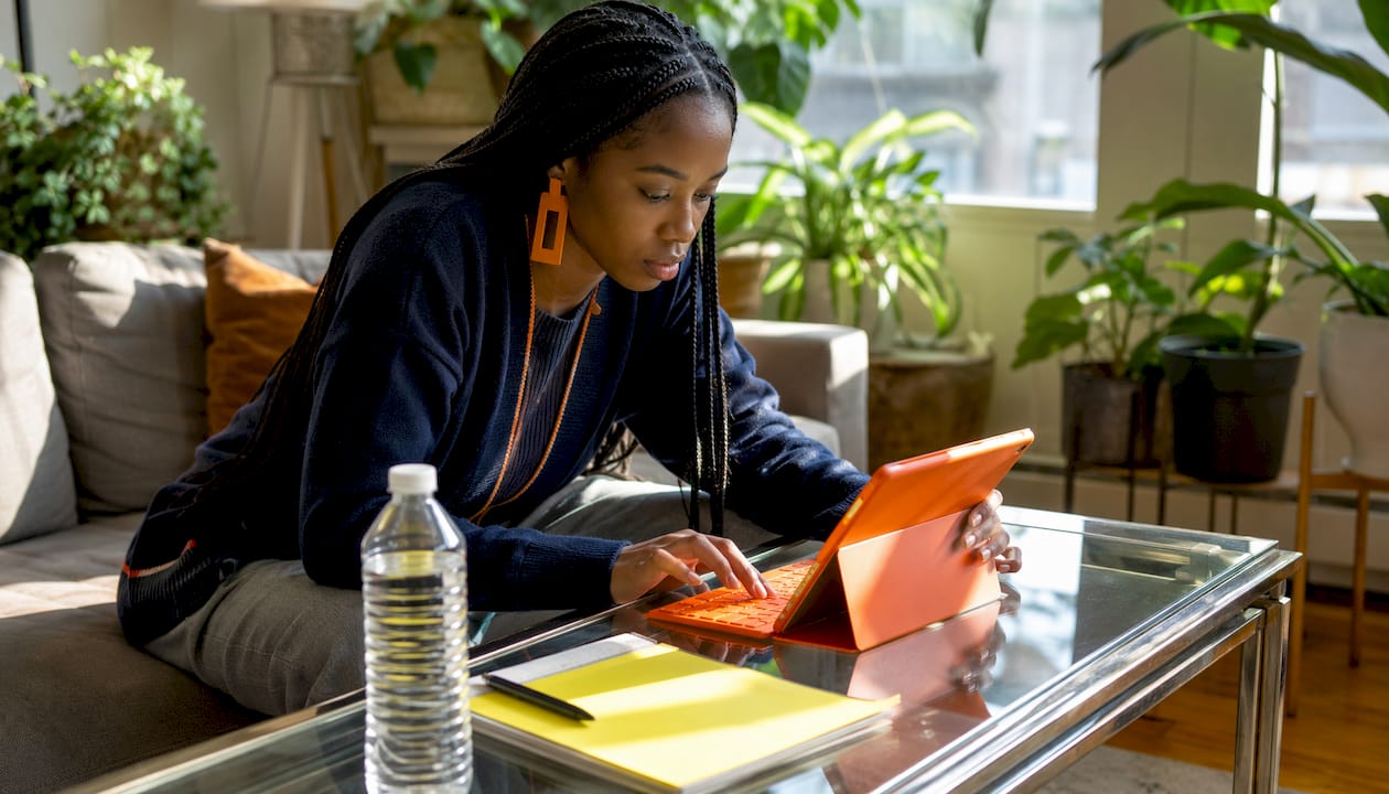 Hands using laptop and tablet for job search