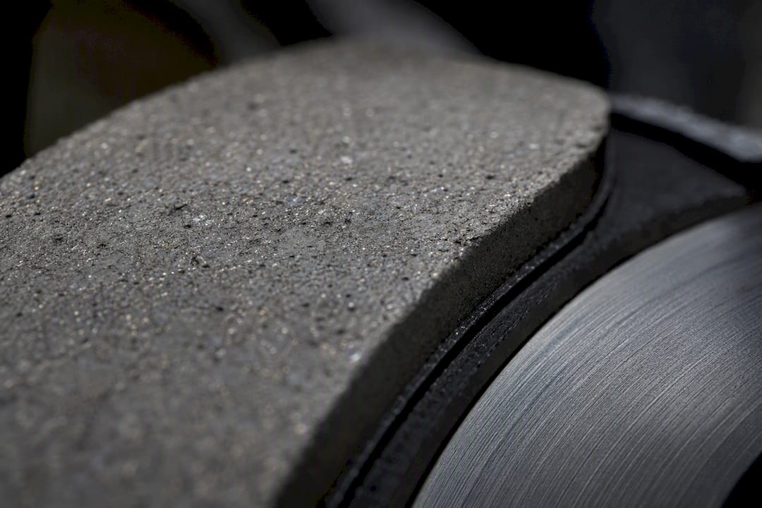 Close-up of ceramic brake pad and coated rotor surface