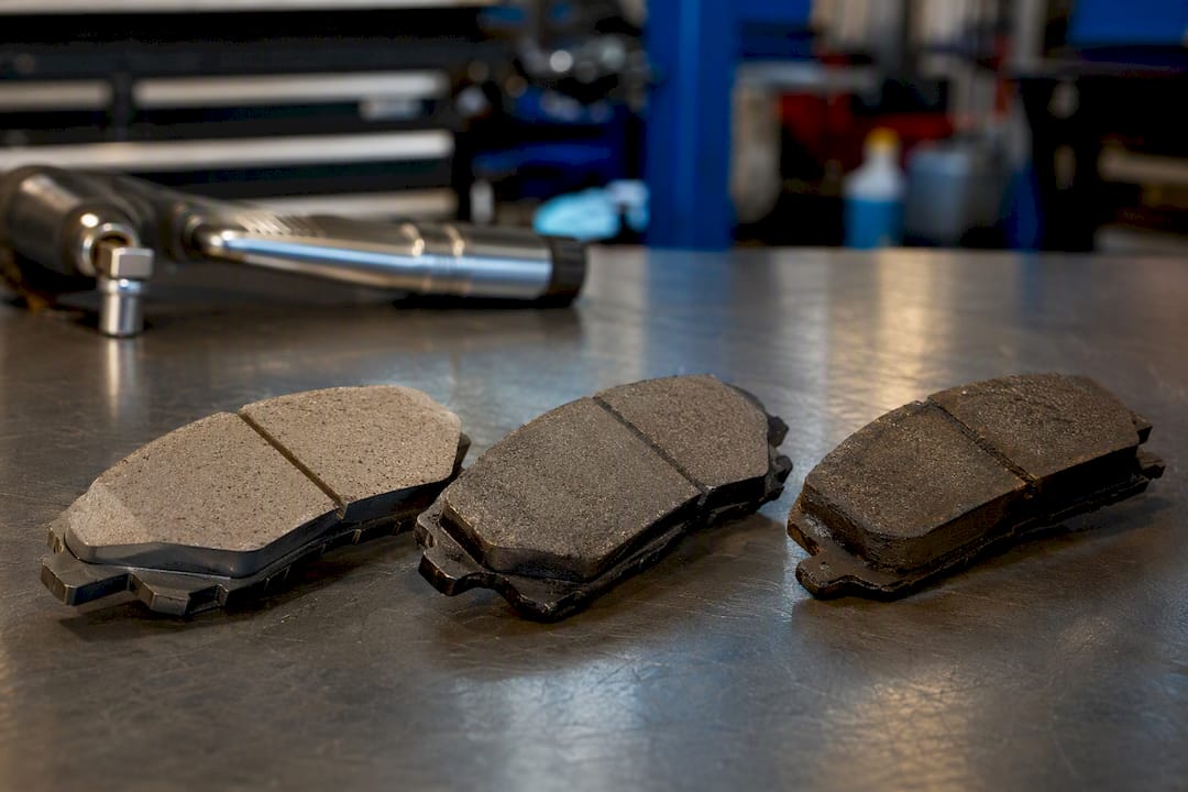Three brake pads types on workbench