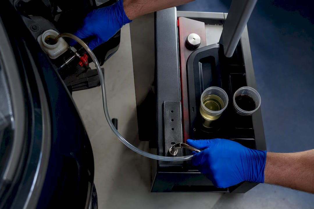 Technician performing a brake fluid flush