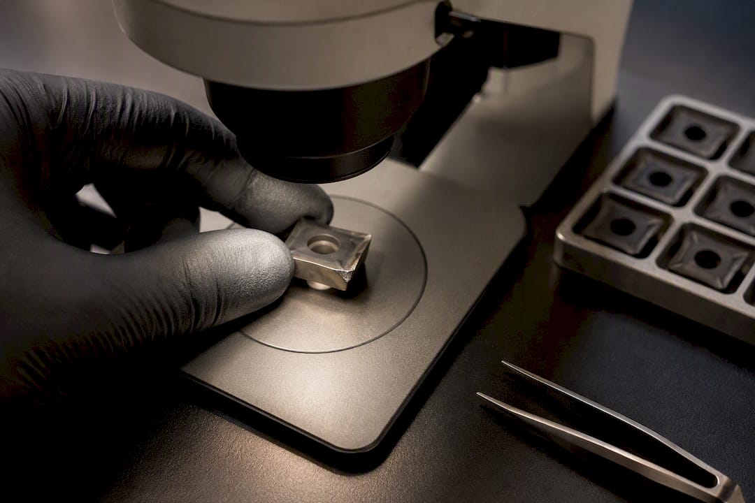 Machinist measuring carbide insert flank wear