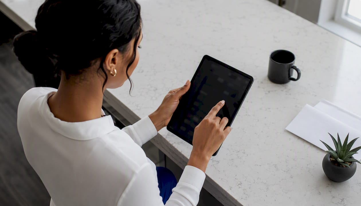 Hands controlling CRE automation on tablet