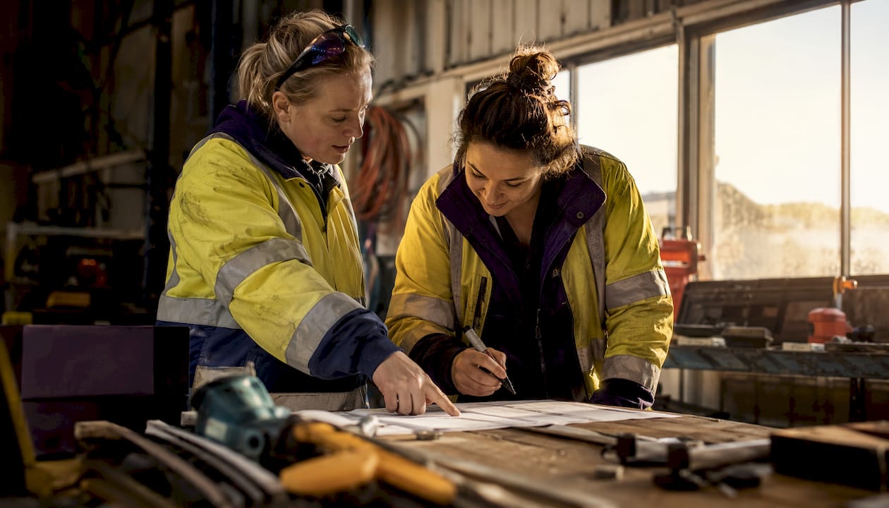 Two tradies discussing onboarding by van