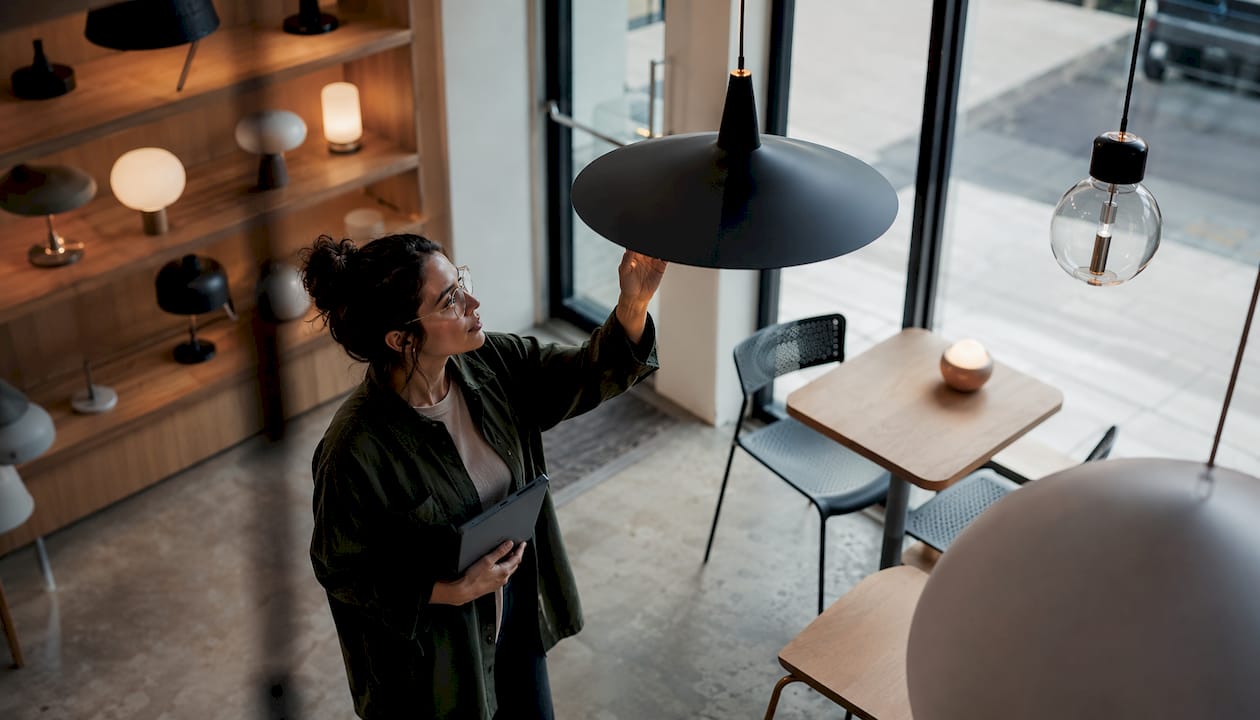 Lighting designer inspecting chandelier in store