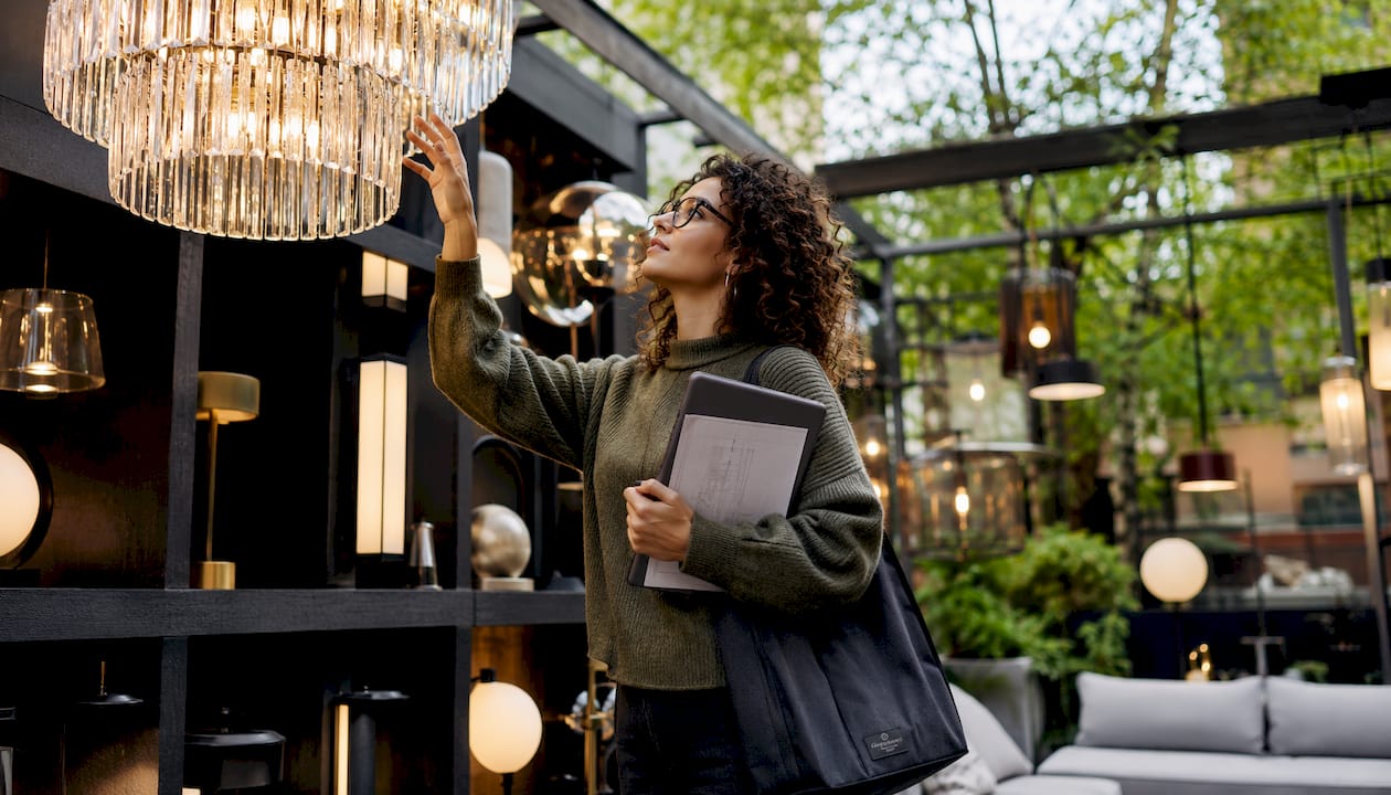 Woman inspecting chandelier in showroom