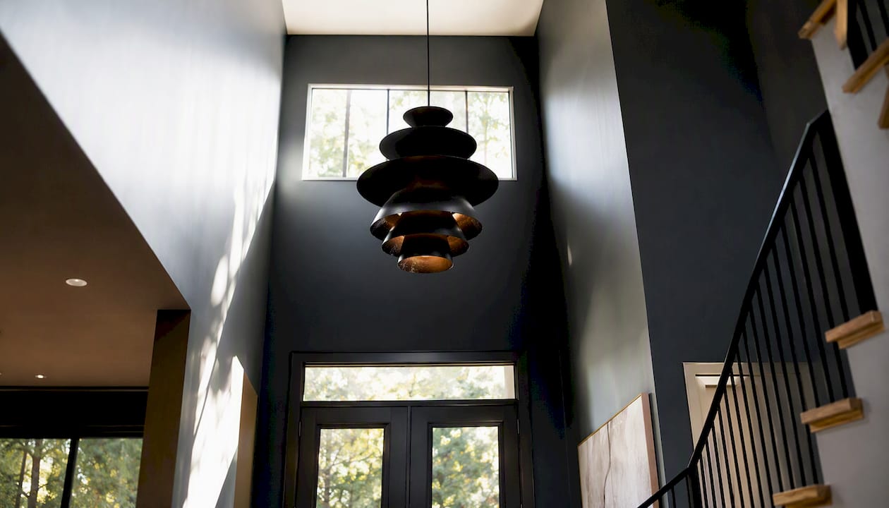 Large black pendant chandelier in two-story foyer