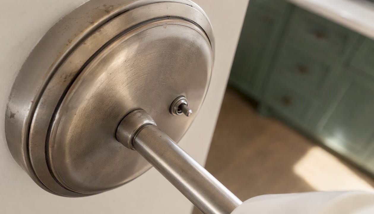 Close-up of worn plated lighting fixture finish
